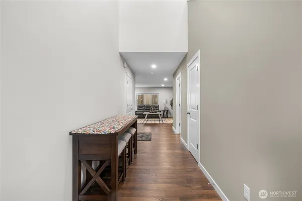 a hallway with wooden floor a sink and entryway