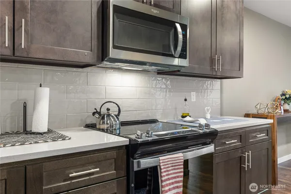 a kitchen with a stove microwave and sink