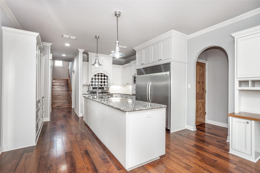 1218 Walter Street Lindsay, TX 76240 - Photo 13 of 40 a kitchen with stainless steel appliances kitchen island granite countertop a refrigerator a oven and a wooden floors
