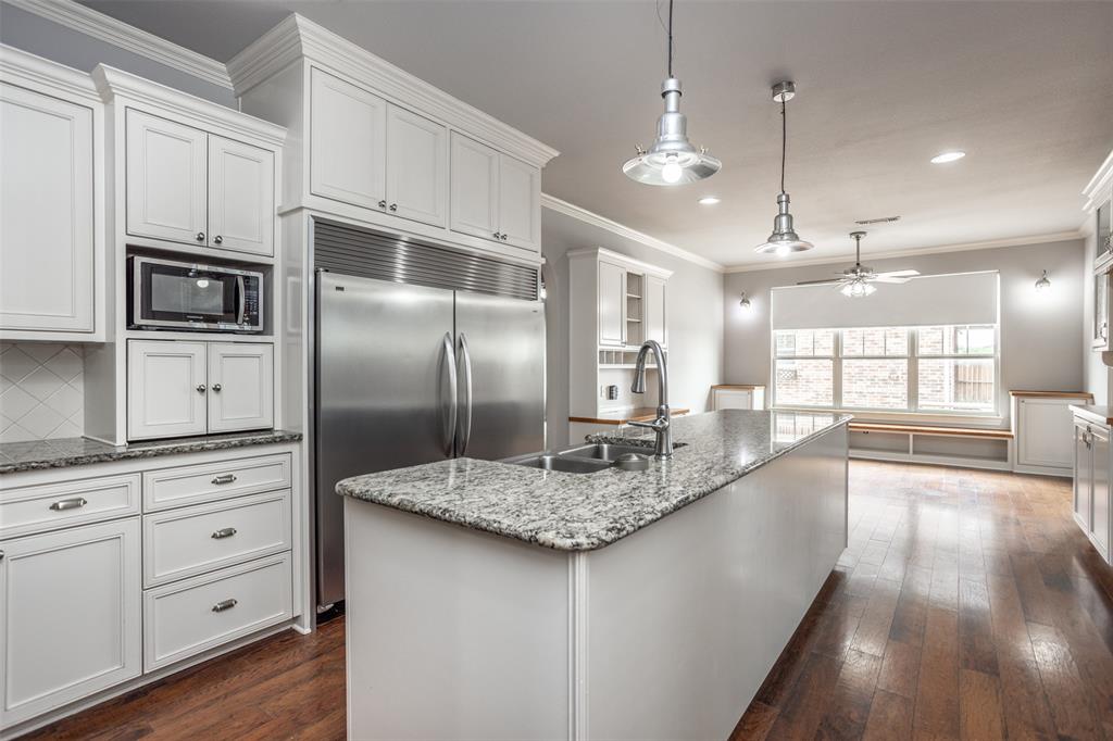 1218 Walter Street Lindsay, TX 76240 - Photo 14 of 40 a large kitchen with granite countertop a large counter top a sink stainless steel appliances and cabinets