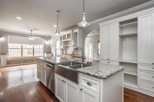 a kitchen with stainless steel appliances granite countertop a sink and stove