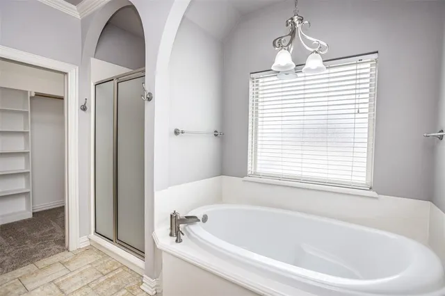 a white bath tub sitting next to a window