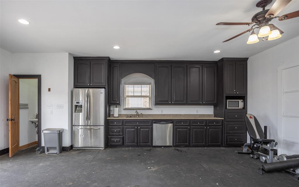 1218 Walter Street Lindsay, TX 76240 - Photo 34 of 40 a kitchen with sink a refrigerator and cabinets