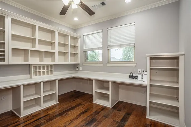 a view of a workspace with furniture and a window
