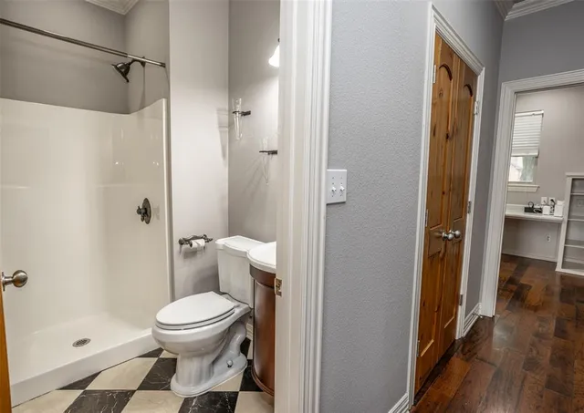 a bathroom with a toilet and a shower