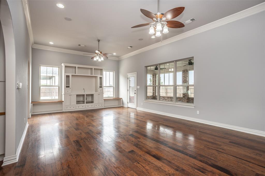 1218 Walter Street Lindsay, TX 76240 - Photo 10 of 40 a view of an empty room with a window and wooden floor