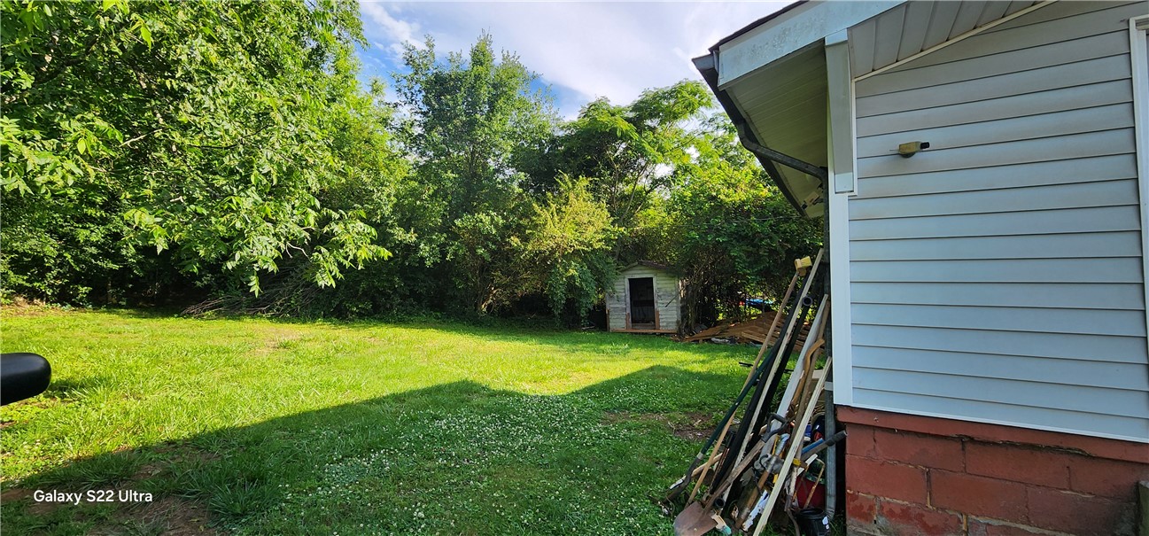 105 Hope Avenue Seneca, SC 29678 - Photo 30 of 33 A spacious yard with mature trees and a charming storage shed awaits your personal touch.