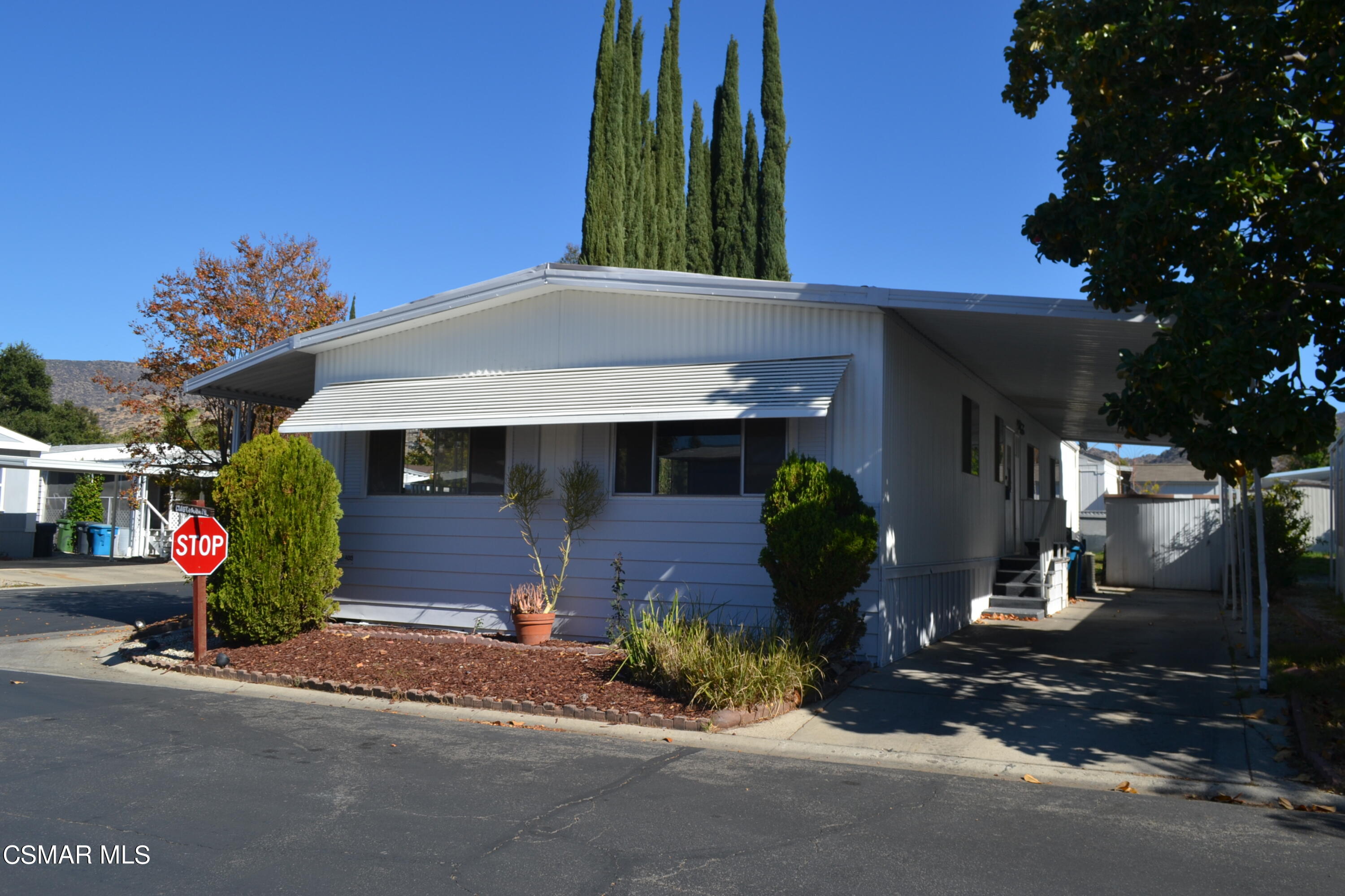 6480 Katherine Road, Unit 70 Simi Valley, CA 93063 - Photo 1 of 28 a front view of a house with garden