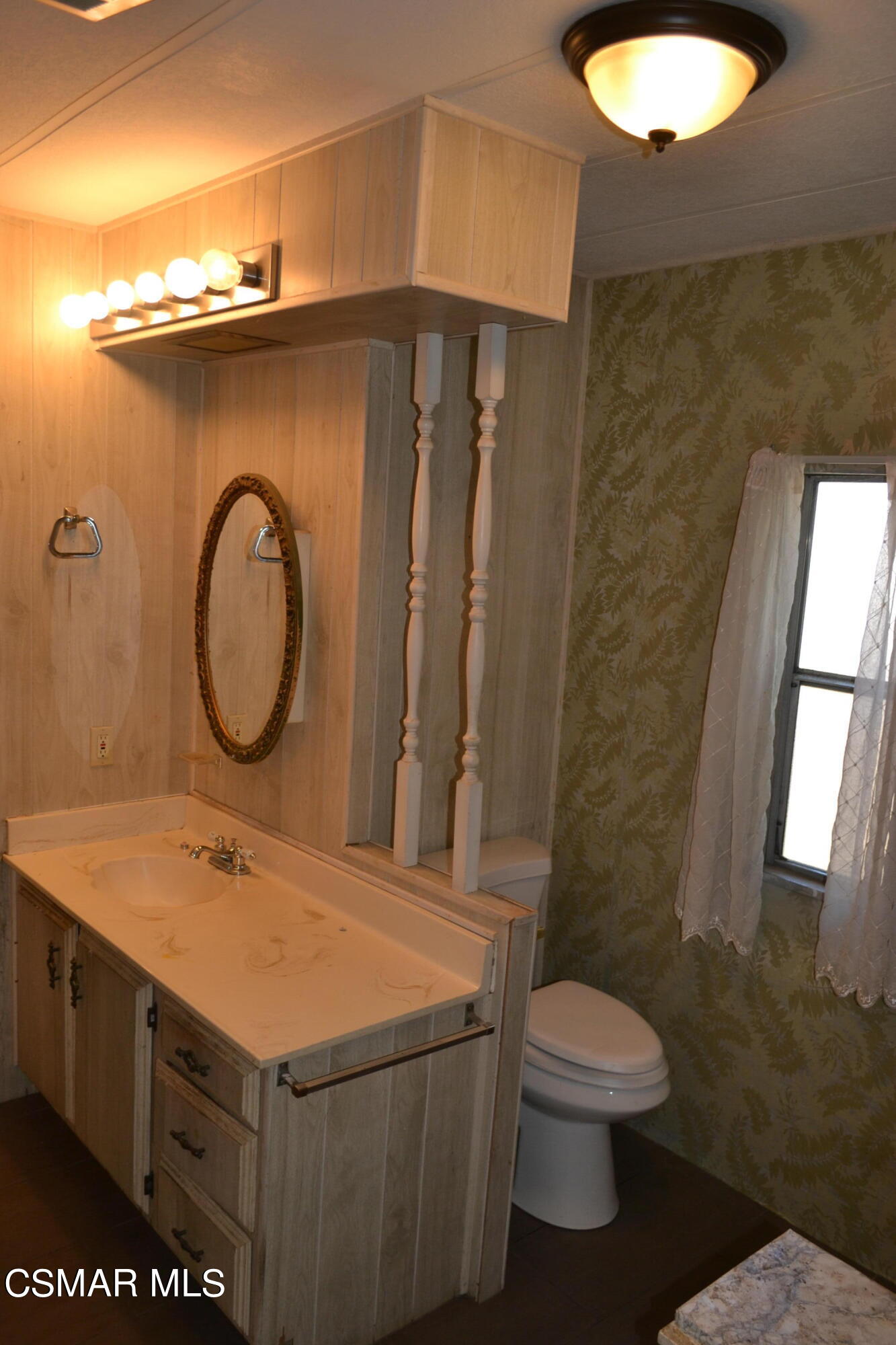 6480 Katherine Road, Unit 70 Simi Valley, CA 93063 - Photo 11 of 28 a bathroom with a sink mirror vanity and toilet