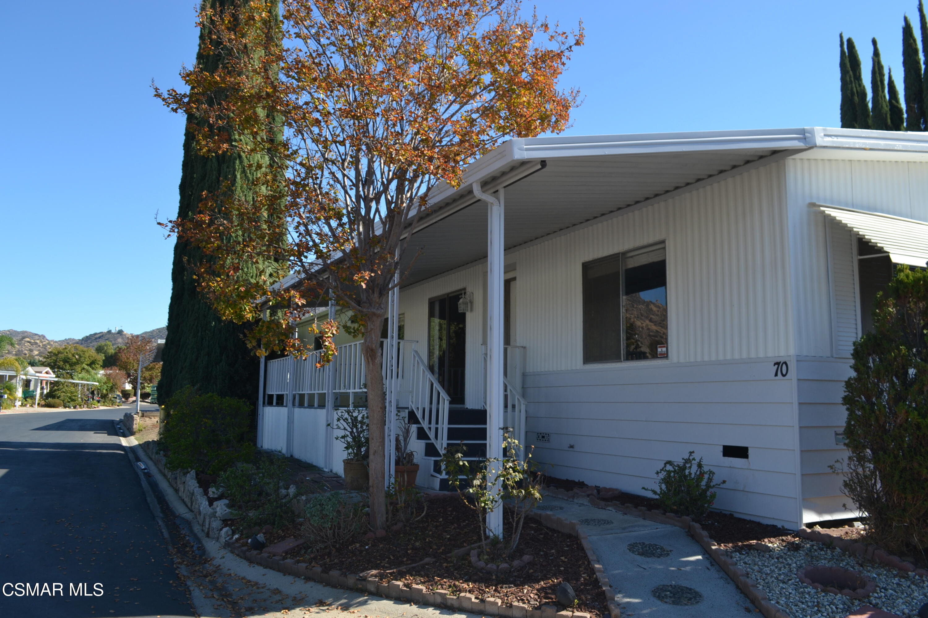 6480 Katherine Road, Unit 70 Simi Valley, CA 93063 - Photo 14 of 28 a front view of a house with garden