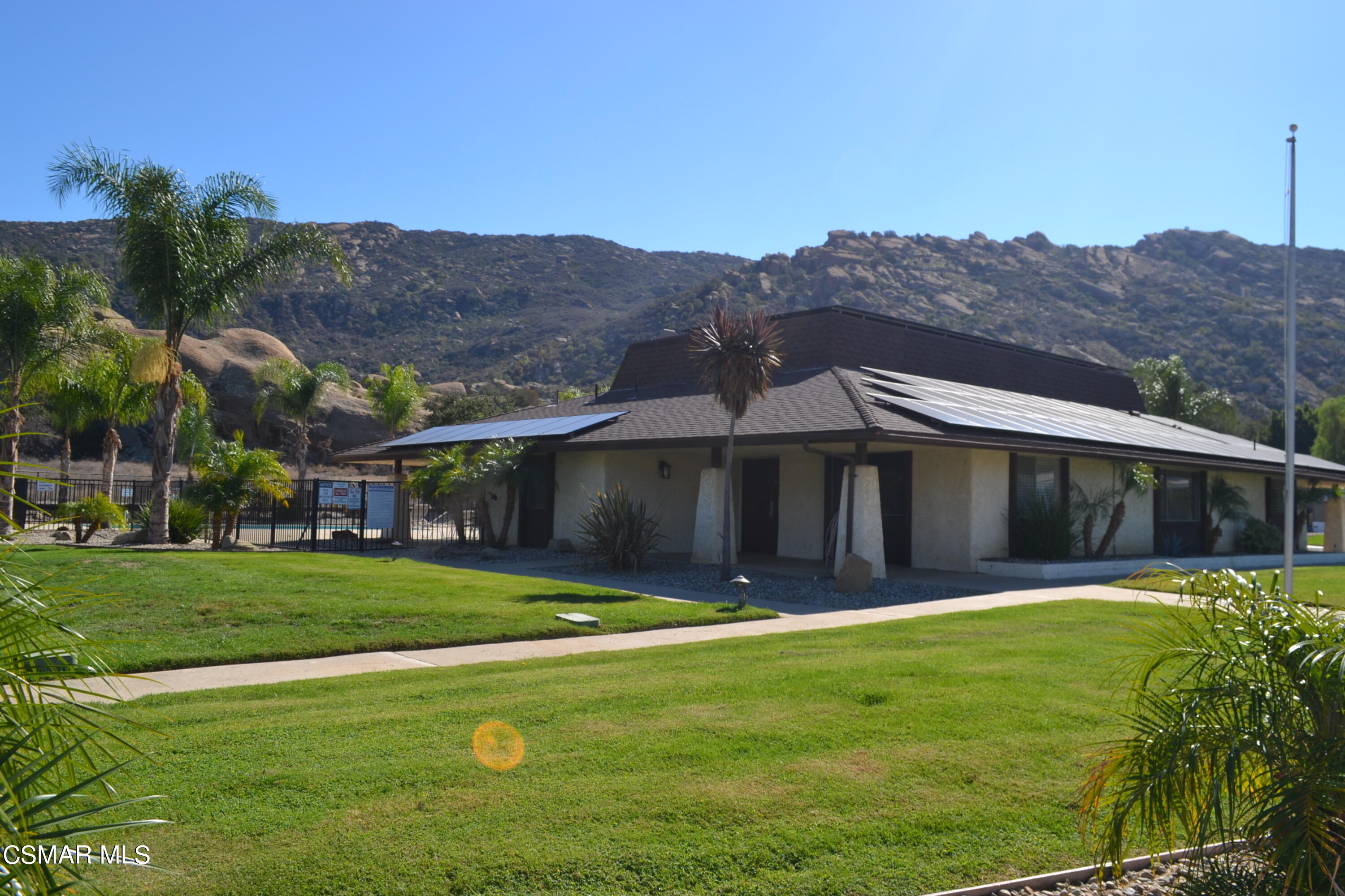 6480 Katherine Road, Unit 70 Simi Valley, CA 93063 - Photo 18 of 28 a view of a house with a yard and a garden