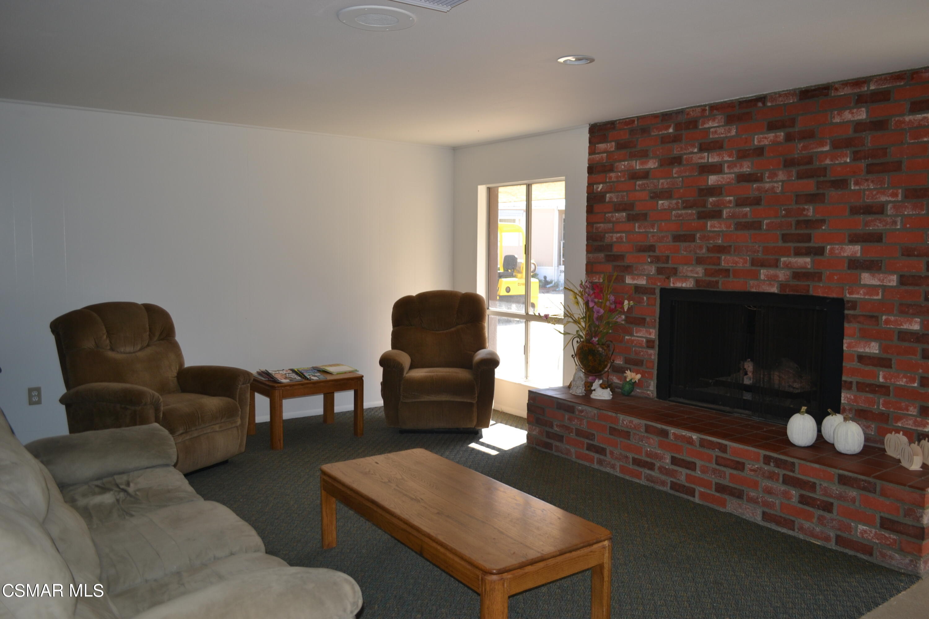 6480 Katherine Road, Unit 70 Simi Valley, CA 93063 - Photo 20 of 28 a living room with furniture and a fireplace