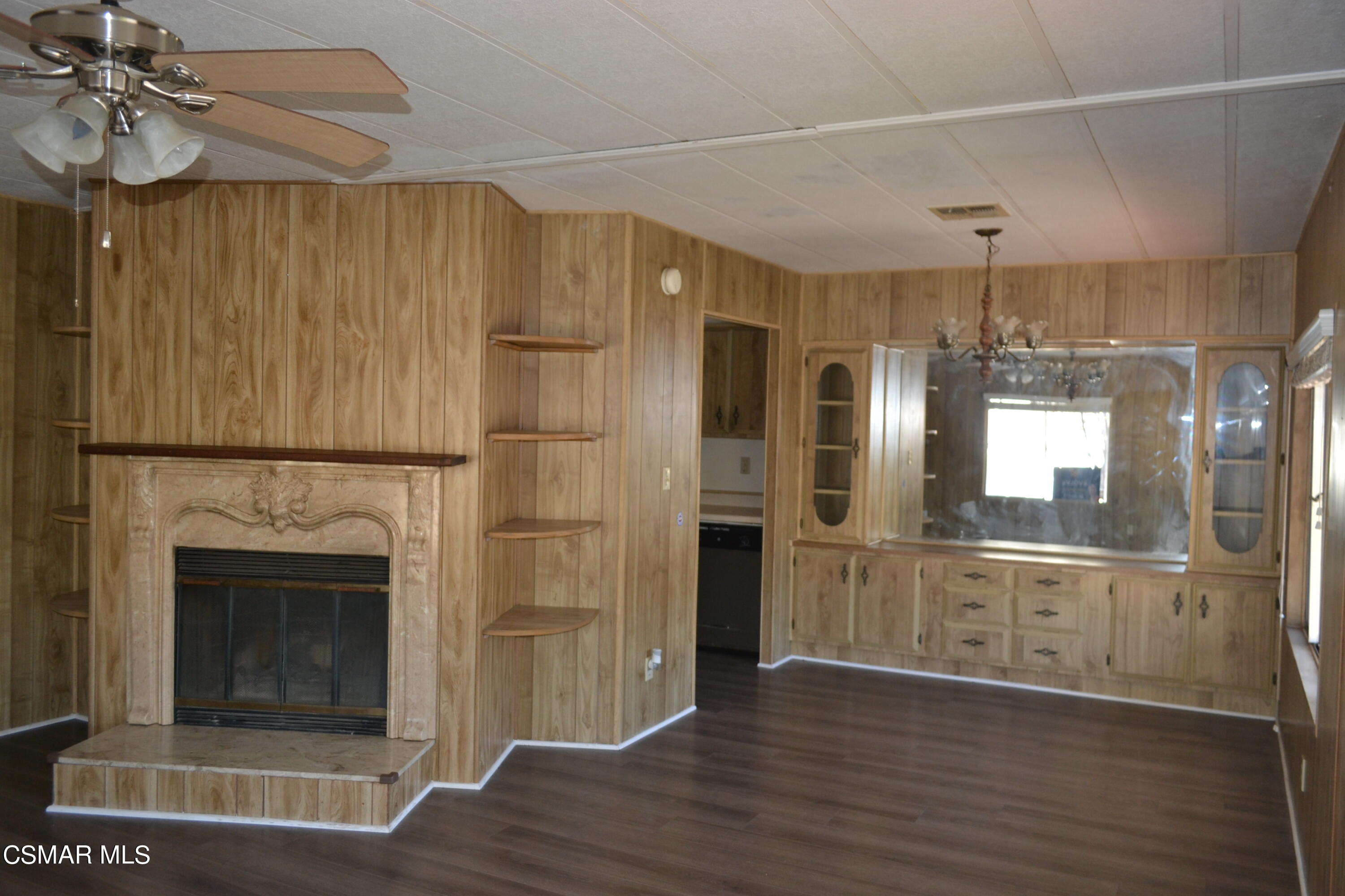 6480 Katherine Road, Unit 70 Simi Valley, CA 93063 - Photo 3 of 28 a view of a hallway with wooden floor and a kitchen