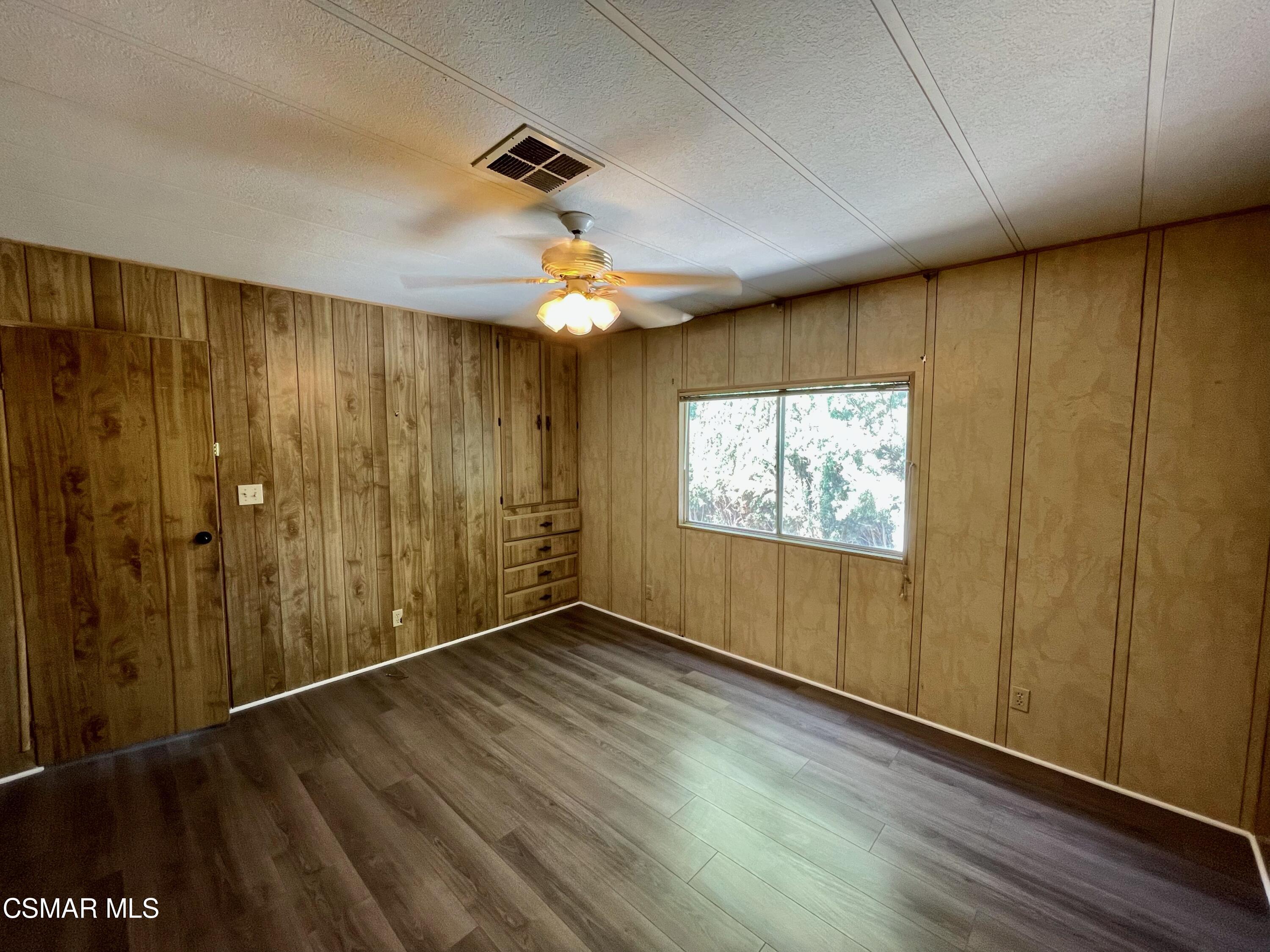 6480 Katherine Road, Unit 70 Simi Valley, CA 93063 - Photo 7 of 28 wooden floor in an empty room with a window
