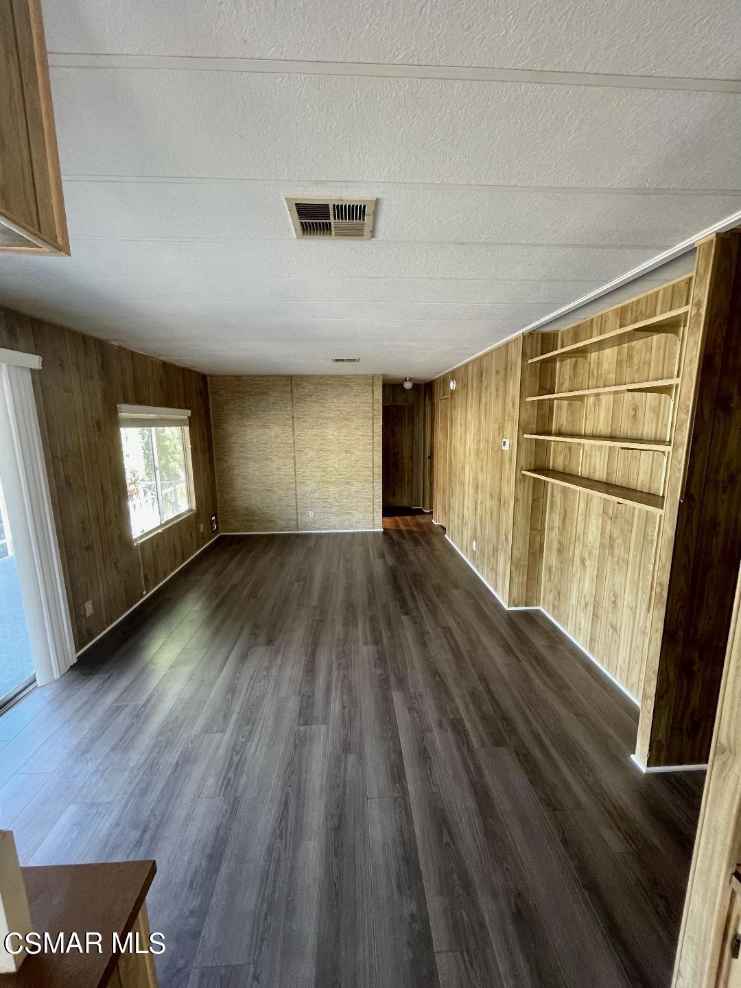 6480 Katherine Road, Unit 70 Simi Valley, CA 93063 - Photo 9 of 28 a view of wooden floor in an empty room with a window