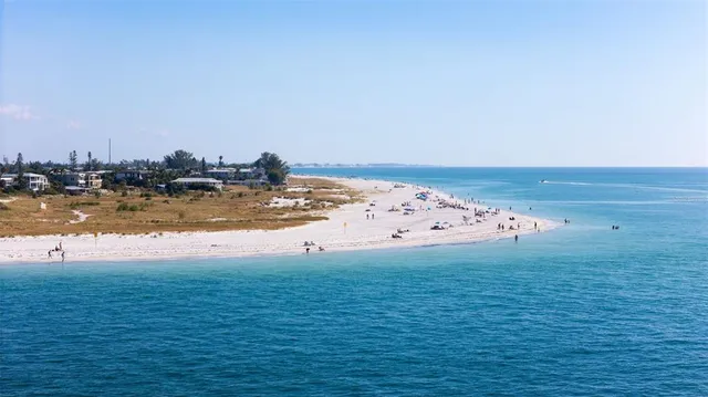 an aerial view of a ocean with beach