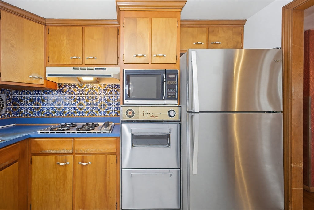 111 Almy Road Somerset, MA 02726 - Photo 11 of 42 a kitchen with stainless steel appliances a refrigerator and a stove