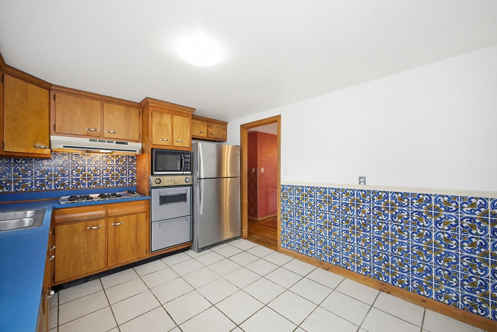 111 Almy Road Somerset, MA 02726 - Photo 12 of 42 a kitchen with a refrigerator and cabinets