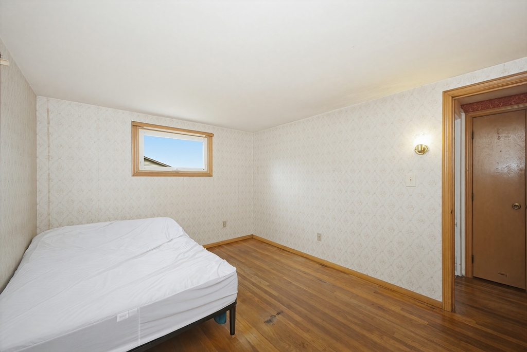 111 Almy Road Somerset, MA 02726 - Photo 18 of 42 a bedroom with a bed and wooden floor