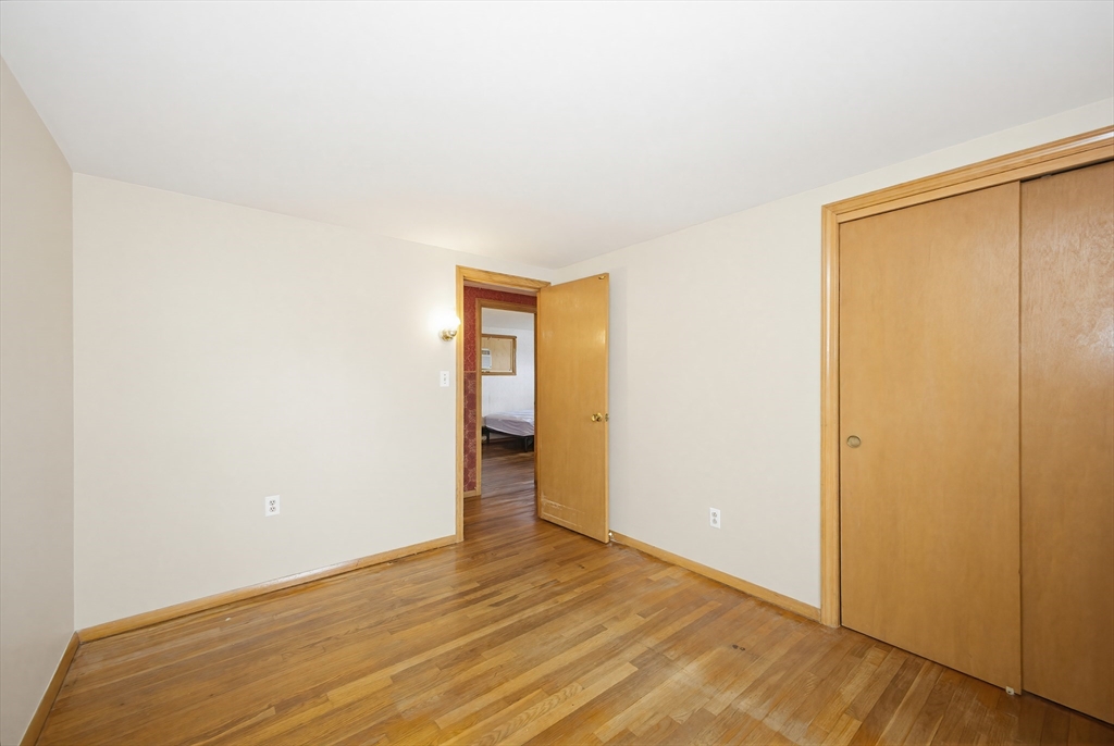 111 Almy Road Somerset, MA 02726 - Photo 21 of 42 a view of an empty room with wooden floor and closet