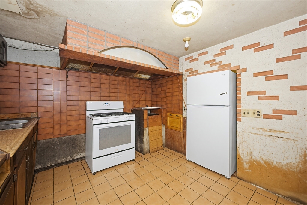 111 Almy Road Somerset, MA 02726 - Photo 27 of 42 a kitchen with a refrigerator and a stove