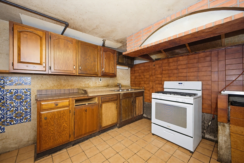 111 Almy Road Somerset, MA 02726 - Photo 28 of 42 a kitchen with granite countertop cabinets stainless steel appliances and a counter space