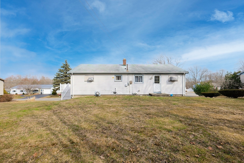 111 Almy Road Somerset, MA 02726 - Photo 40 of 42 a front view of a house with a yard and garage