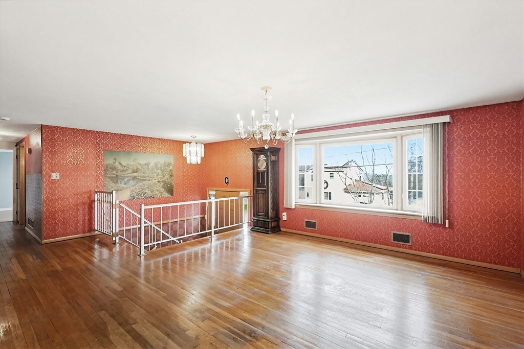 111 Almy Road Somerset, MA 02726 - Photo 5 of 42 an empty room with wooden floor and windows
