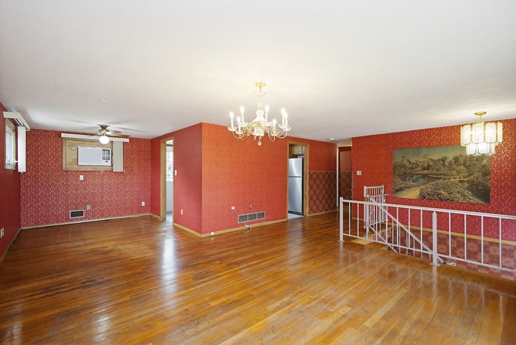 111 Almy Road Somerset, MA 02726 - Photo 6 of 42 a view of a livingroom with wooden floor and chandelier