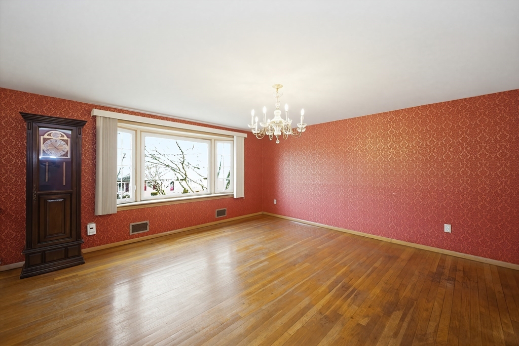 111 Almy Road Somerset, MA 02726 - Photo 8 of 42 a view of an empty room with wooden floor and a window