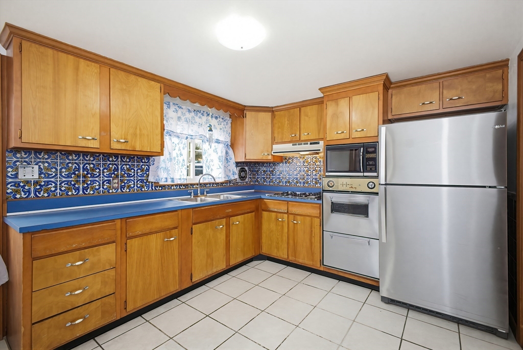 111 Almy Road Somerset, MA 02726 - Photo 9 of 42 a kitchen with granite countertop a sink stainless steel appliances and cabinets