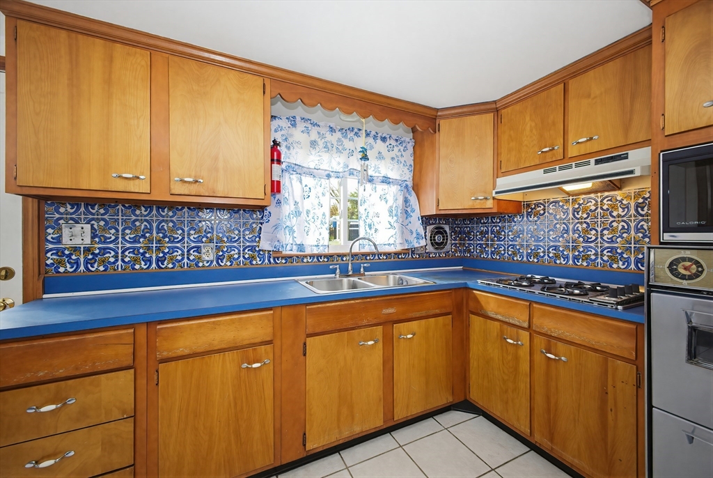 111 Almy Road Somerset, MA 02726 - Photo 10 of 42 a kitchen with stainless steel appliances granite countertop a sink and cabinets