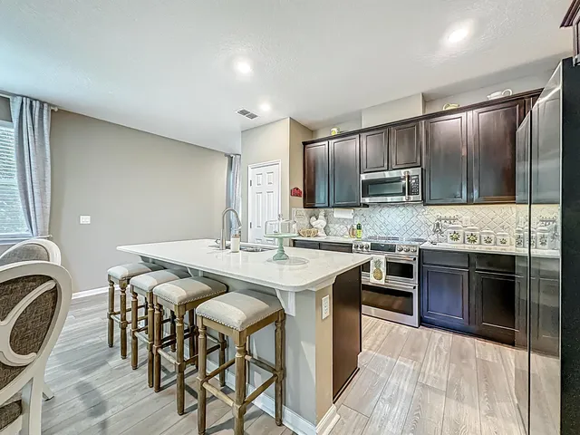 a kitchen with a sink cabinets and wooden floor