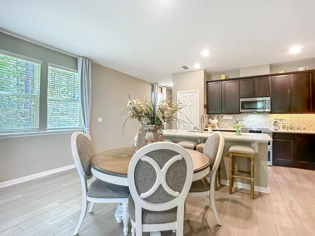 a kitchen with kitchen island granite countertop stainless steel appliances cabinets a sink and a stove