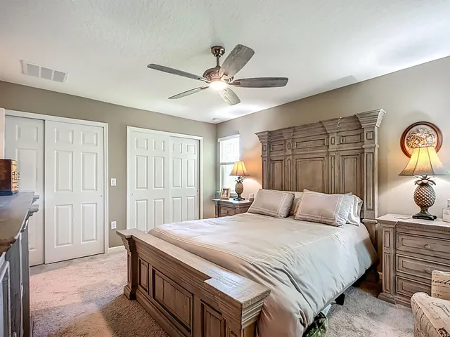 a bedroom with a bed and a chandelier