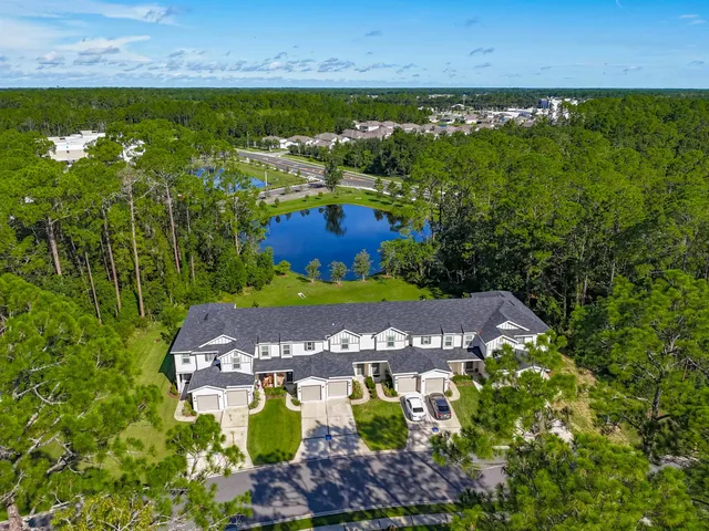 an aerial view of a house with yard swimming pool and outdoor seating