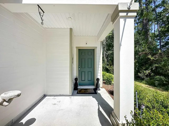 a view of a door and wooden floor in front of a house
