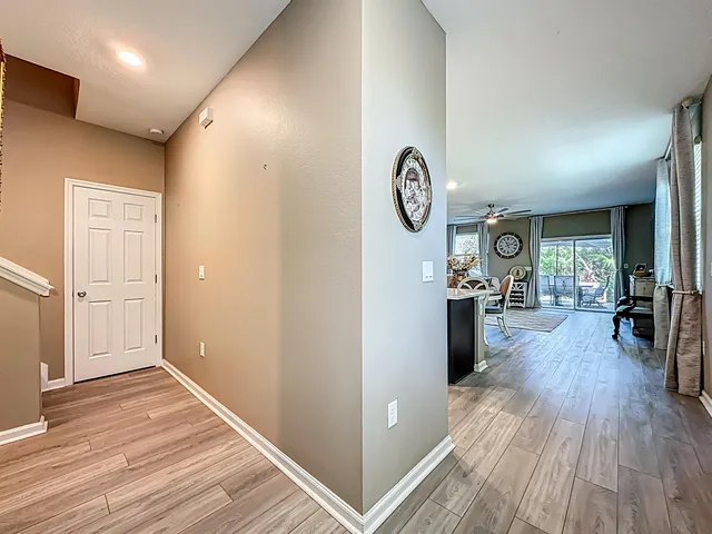 a view of a hallway with wooden floor