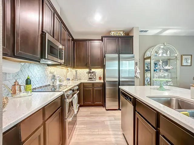 a kitchen with a sink stove and cabinets