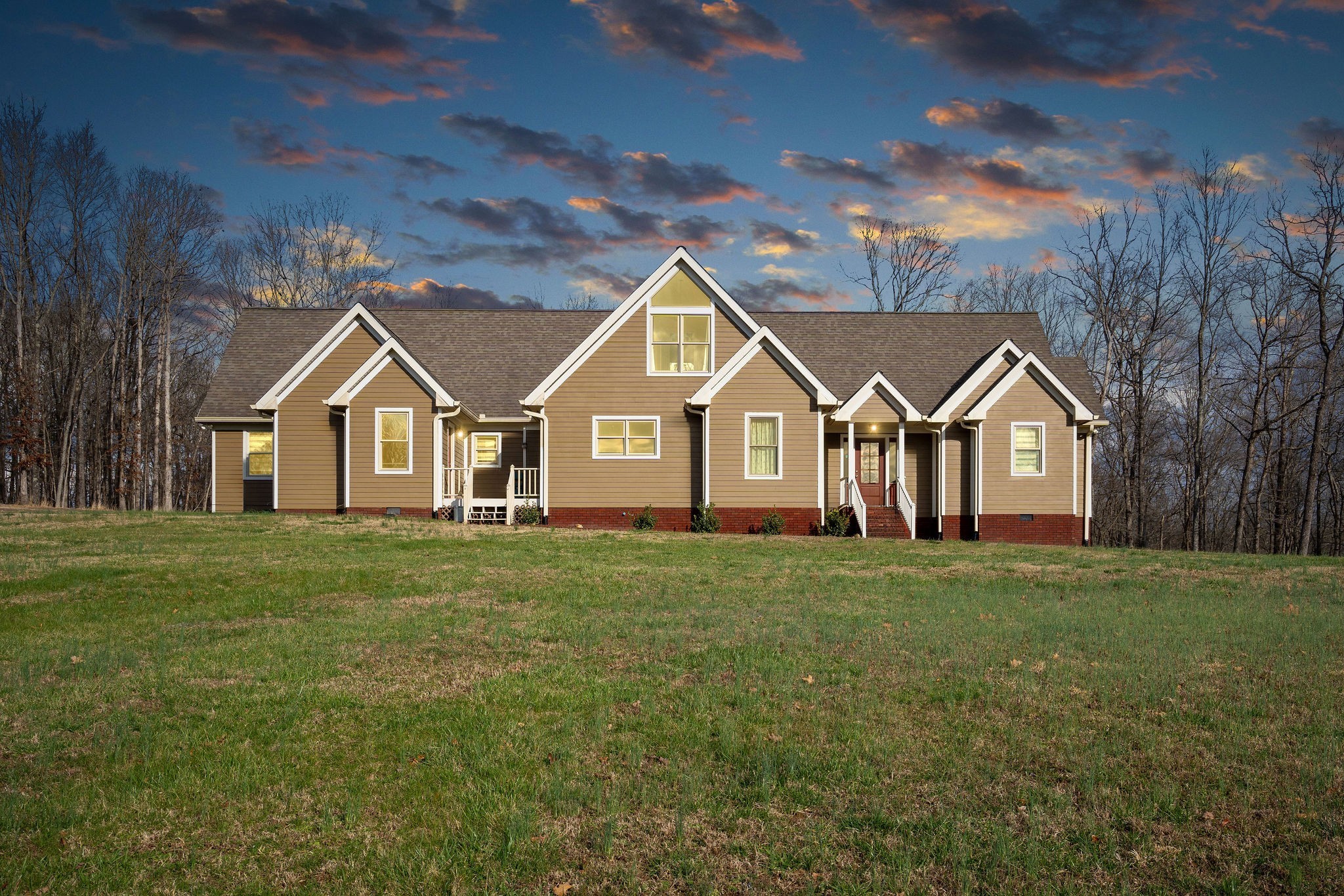 a view of a house with yard and tree s