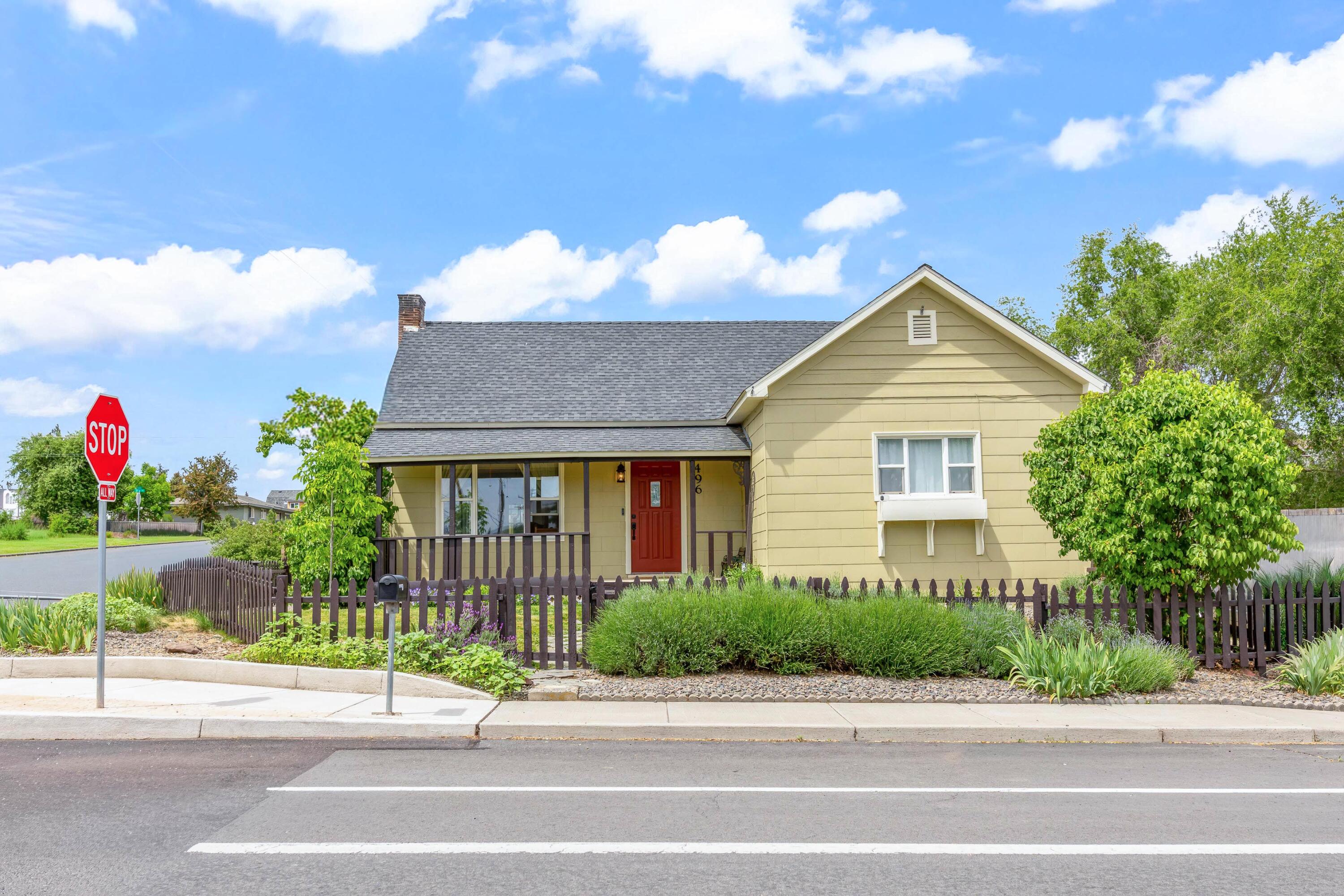 496 Southwest 2nd Street Madras, OR 97741 - Photo 1 of 37 a front view of a house with a yard and potted plants
