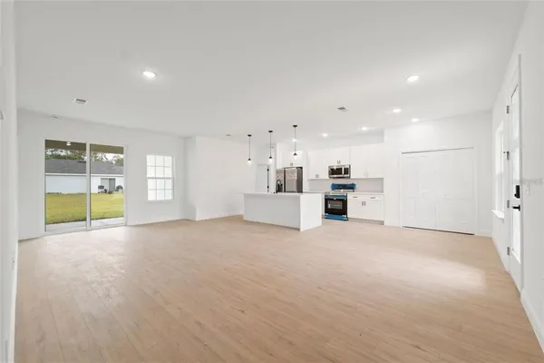 a view of a kitchen with a sink and a refrigerator