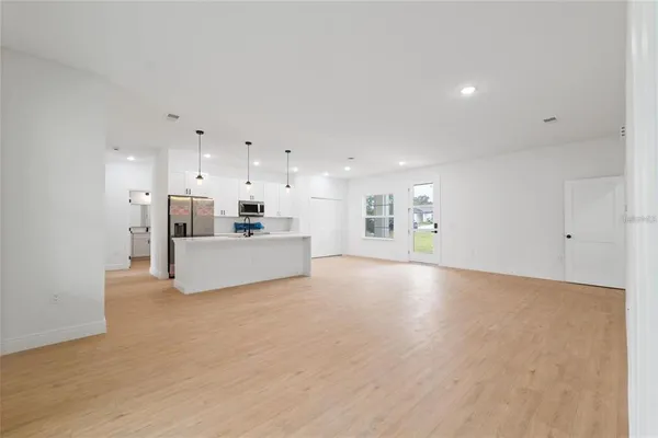 a kitchen with stainless steel appliances a refrigerator sink and microwave