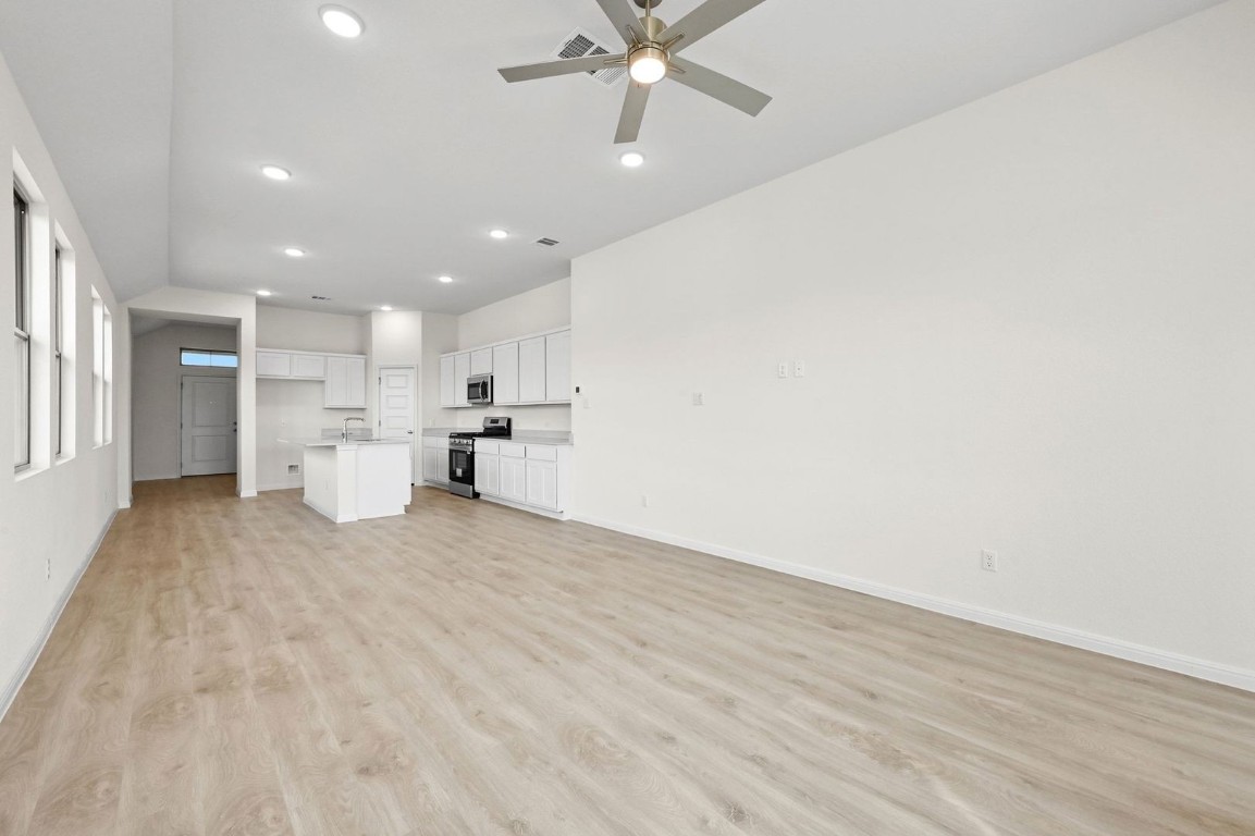 270 Bendecido Loop Elgin, TX 78621 - Photo 12 of 39 a view of a kitchen with a sink and wooden cabinet