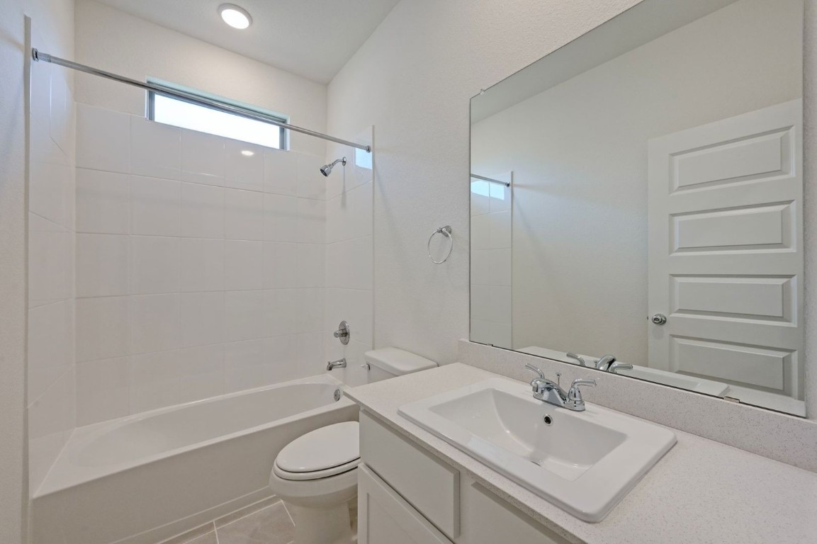 270 Bendecido Loop Elgin, TX 78621 - Photo 21 of 39 a bathroom with a sink a toilet and shower