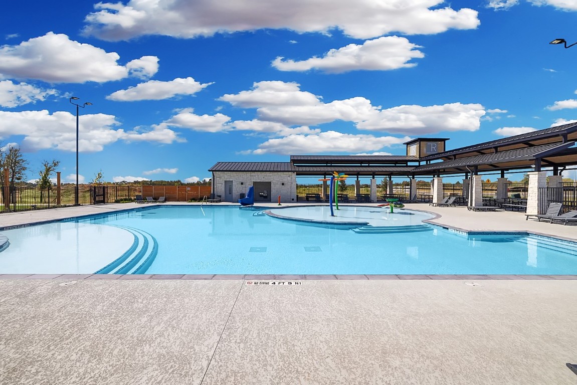 270 Bendecido Loop Elgin, TX 78621 - Photo 30 of 39 a view of a swimming pool with a patio