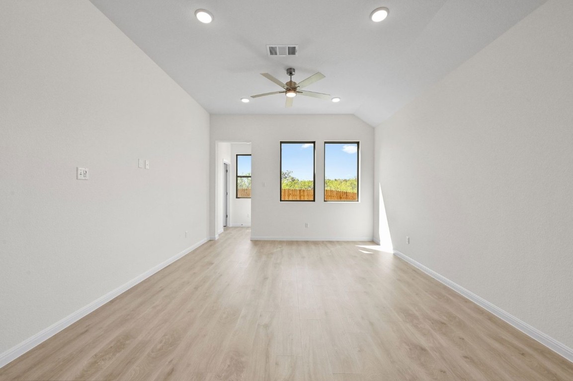 270 Bendecido Loop Elgin, TX 78621 - Photo 10 of 39 an empty room with a window and wooden floor