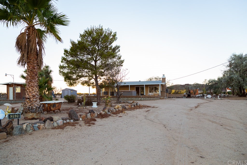 a row of lawn chairs with wooden fence