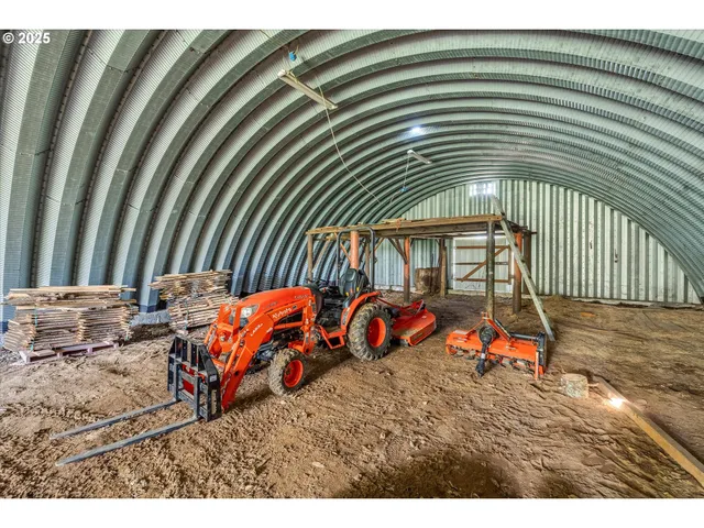 a backyard of a house with barbeque oven table and chairs