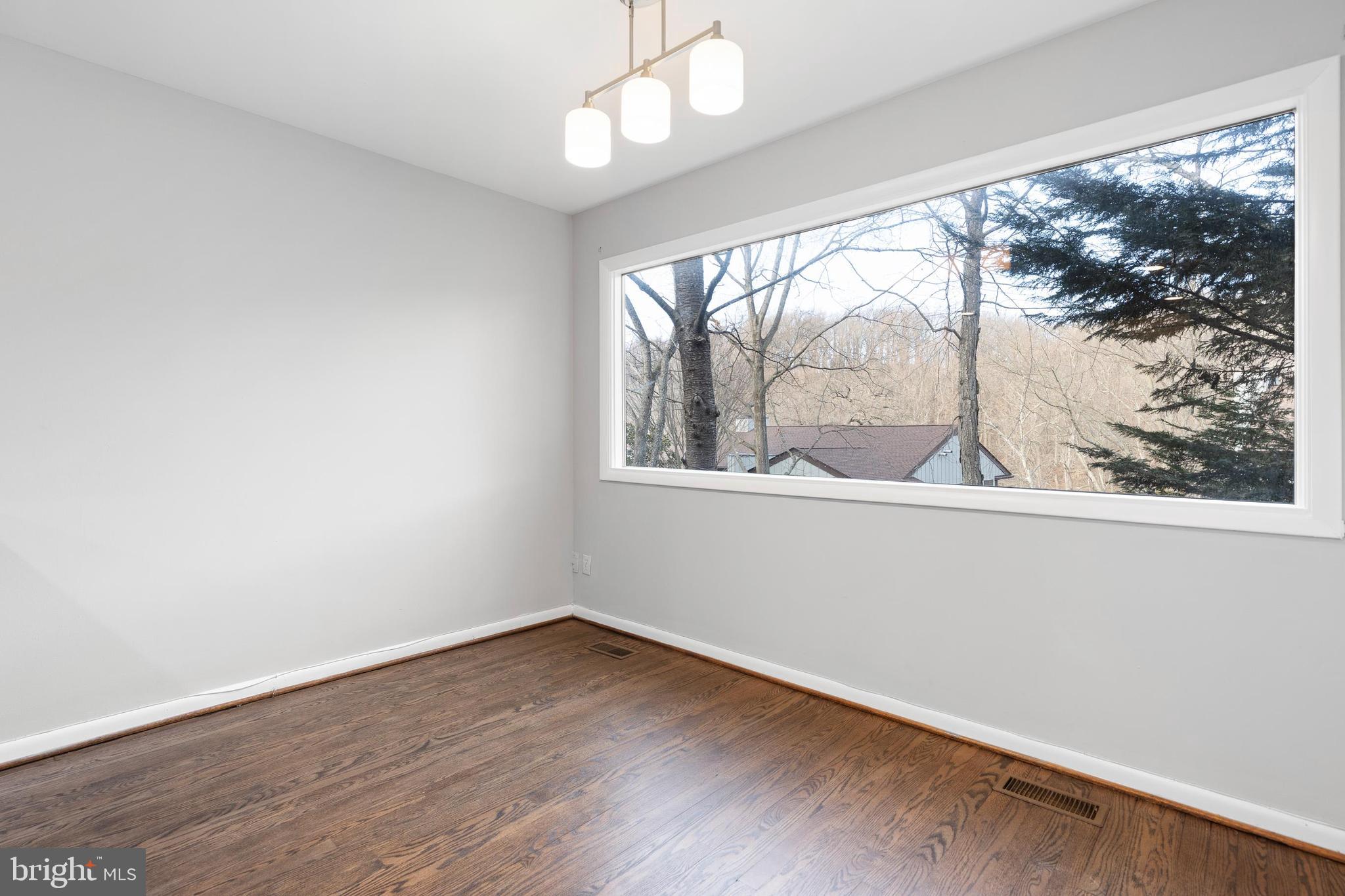 10 Brandywine Falls Road, Unit C010 Wilmington, DE 19806 - Photo 15 of 29 wooden floor in an empty room with a window